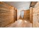 Rustic bedroom featuring wood-paneled walls, light-colored floor, and a corrugated metal ceiling at 3721 S 575 W, Trafalgar, IN 46181