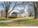 Charming single-story home with a front yard, wooden deck, gravel driveway and storage shed at 3721 S 575 W, Trafalgar, IN 46181
