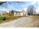 Exterior of house with a wooden deck, gravel driveway, small patches of green grass, and a storage shed at 3721 S 575 W, Trafalgar, IN 46181