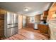 Open kitchen featuring stainless steel appliances, wood cabinets and corrugated metal ceiling at 3721 S 575 W, Trafalgar, IN 46181