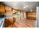 Kitchen with stainless steel appliances, wood cabinets, wood laminate flooring and corrugated metal ceiling at 3721 S 575 W, Trafalgar, IN 46181