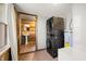 Laundry area with wood-paneled walls and a view into the full bathroom at 3721 S 575 W, Trafalgar, IN 46181