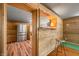 Living room with wood paneled walls, an open bar with stool, and stainless steel refrigerator at 3721 S 575 W, Trafalgar, IN 46181
