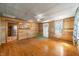 Wide open living room with wooden walls and doorway to the kitchen with stainless steel appliances at 3721 S 575 W, Trafalgar, IN 46181