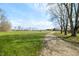 Grassy lawn adjacent to long gravel driveway at 3721 S 575 W, Trafalgar, IN 46181
