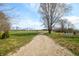 Long gravel driveway with a grassy yard at 3721 S 575 W, Trafalgar, IN 46181