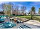 Green grass and patio furniture highlight the beauty of this manicured backyard garden with a raised garden bed at 3926 Rookwood Ave, Indianapolis, IN 46208