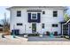 Charming white house with a purple accent, surrounded by gravel, patio furniture, and landscaping at 3926 Rookwood Ave, Indianapolis, IN 46208