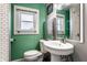 Well-lit bathroom with white fixtures, a bright window, and modern subway tiling at 3926 Rookwood Ave, Indianapolis, IN 46208