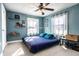 Bright bedroom with blue accents, featuring a ceiling fan and plenty of natural light at 3926 Rookwood Ave, Indianapolis, IN 46208