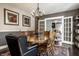 Elegant dining room with a round table, black accent chair, and view of the sunroom through French doors at 3926 Rookwood Ave, Indianapolis, IN 46208