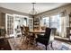 Light-filled dining room with a round table, chandelier, and adjacent sitting room with French doors at 3926 Rookwood Ave, Indianapolis, IN 46208