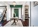 Inviting entryway features hardwood floors, a chandelier, and a green door, offering a warm welcome at 3926 Rookwood Ave, Indianapolis, IN 46208