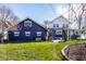 Charming two-story house with a blue accent wall, surrounded by well-kept landscaping at 3926 Rookwood Ave, Indianapolis, IN 46208