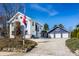 Charming two-story home with a gravel driveway and detached garage, adorned with an American flag at 3926 Rookwood Ave, Indianapolis, IN 46208