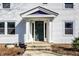A white door, flanked by columns, leads into this charming home, with windows on either side at 3926 Rookwood Ave, Indianapolis, IN 46208