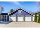 Three-car garage with white doors and dark purple siding and white trim; the address is displayed above the doors at 3926 Rookwood Ave, Indianapolis, IN 46208