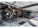 Spacious garage featuring a concrete floor, a ladder, storage shelves, and wooden rafters for overhead storage at 3926 Rookwood Ave, Indianapolis, IN 46208