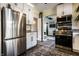 Updated kitchen with stainless steel appliances, white cabinets, and an open floorplan at 3926 Rookwood Ave, Indianapolis, IN 46208