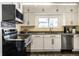 Well-lit kitchen with stainless steel appliances, white cabinets, and stylish countertops at 3926 Rookwood Ave, Indianapolis, IN 46208
