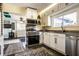 Modern kitchen with stainless steel appliances, white cabinets, and contemporary countertops at 3926 Rookwood Ave, Indianapolis, IN 46208