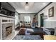 A cozy living room featuring hardwood floors, a fireplace, a crystal chandelier, and stylish decor at 3926 Rookwood Ave, Indianapolis, IN 46208