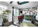 Open-concept living area with bar seating, natural lighting, and stylish green sofa at 3926 Rookwood Ave, Indianapolis, IN 46208