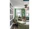 Comfortable reading area with accent chair, ottoman, vintage cabinet, and natural lighting at 3926 Rookwood Ave, Indianapolis, IN 46208