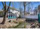 Beautiful backyard pond with natural rock landscaping, white fencing, Adirondack chairs, and manicured grass at 3926 Rookwood Ave, Indianapolis, IN 46208