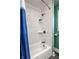 Clean white-tiled shower with a blue curtain and convenient shelving at 3926 Rookwood Ave, Indianapolis, IN 46208