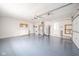 Spacious garage featuring painted walls, sealed concrete floors, laundry hookups, and garage door with opener at 3929 Lee St, Anderson, IN 46011
