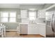 Bright kitchen featuring white cabinetry, stainless steel appliances, and a large window at 3929 Lee St, Anderson, IN 46011