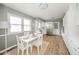 Eat-in kitchen with white cabinets, stainless steel refrigerator, and table with seating at 3929 Lee St, Anderson, IN 46011