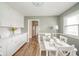 Eat-in kitchen with white cabinets, quartz counters, table with seating and view of stainless fridge at 3929 Lee St, Anderson, IN 46011
