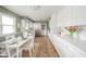 Eat-in kitchen with white cabinets, stainless steel refrigerator, and table with seating at 3929 Lee St, Anderson, IN 46011