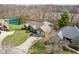 An aerial view of a brick home with pond, mature trees and backyard at 400 S Prairie Trce, Muncie, IN 47304