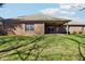 A covered patio accents the brick exterior of this home, complemented by a spacious lawn and large windows at 400 S Prairie Trce, Muncie, IN 47304