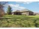 The brick back exterior is enhanced by a covered patio and a lush, well-maintained lawn at 400 S Prairie Trce, Muncie, IN 47304