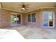 Covered back patio with brick walls, tile flooring, and access to the home at 400 S Prairie Trce, Muncie, IN 47304