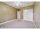 Bedroom featuring a ceiling fan, neutral carpet, generous closet space and neutral wall color at 400 S Prairie Trce, Muncie, IN 47304