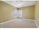 Bedroom featuring a ceiling fan, neutral carpet, and two windows offering abundant natural light at 400 S Prairie Trce, Muncie, IN 47304