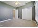 Bedroom featuring a ceiling fan, neutral carpet, generous closet space and abundant natural light at 400 S Prairie Trce, Muncie, IN 47304