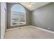 Bedroom featuring a large window, neutral carpet, ceiling fan and generous closet space at 400 S Prairie Trce, Muncie, IN 47304