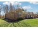 View of the home's brick exterior, showcasing the landscaped yard and curb appeal at 400 S Prairie Trce, Muncie, IN 47304