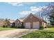 Exterior view of the brick home with a basketball hoop and two-car garage at 400 S Prairie Trce, Muncie, IN 47304
