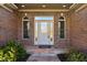 Detailed front entry showcasing brick facade, decorative glass door, and sidelights at 400 S Prairie Trce, Muncie, IN 47304