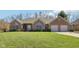 Charming single-story brick home with manicured lawn and two-car garage at 400 S Prairie Trce, Muncie, IN 47304