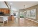 Open kitchen with wooden cabinets, island, and sliding door to the backyard at 400 S Prairie Trce, Muncie, IN 47304