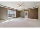 Inviting room with a tray ceiling, neutral colors, and a large window at 400 S Prairie Trce, Muncie, IN 47304