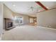 Large living room showing fireplace, neutral colors, and view of the kitchen at 400 S Prairie Trce, Muncie, IN 47304